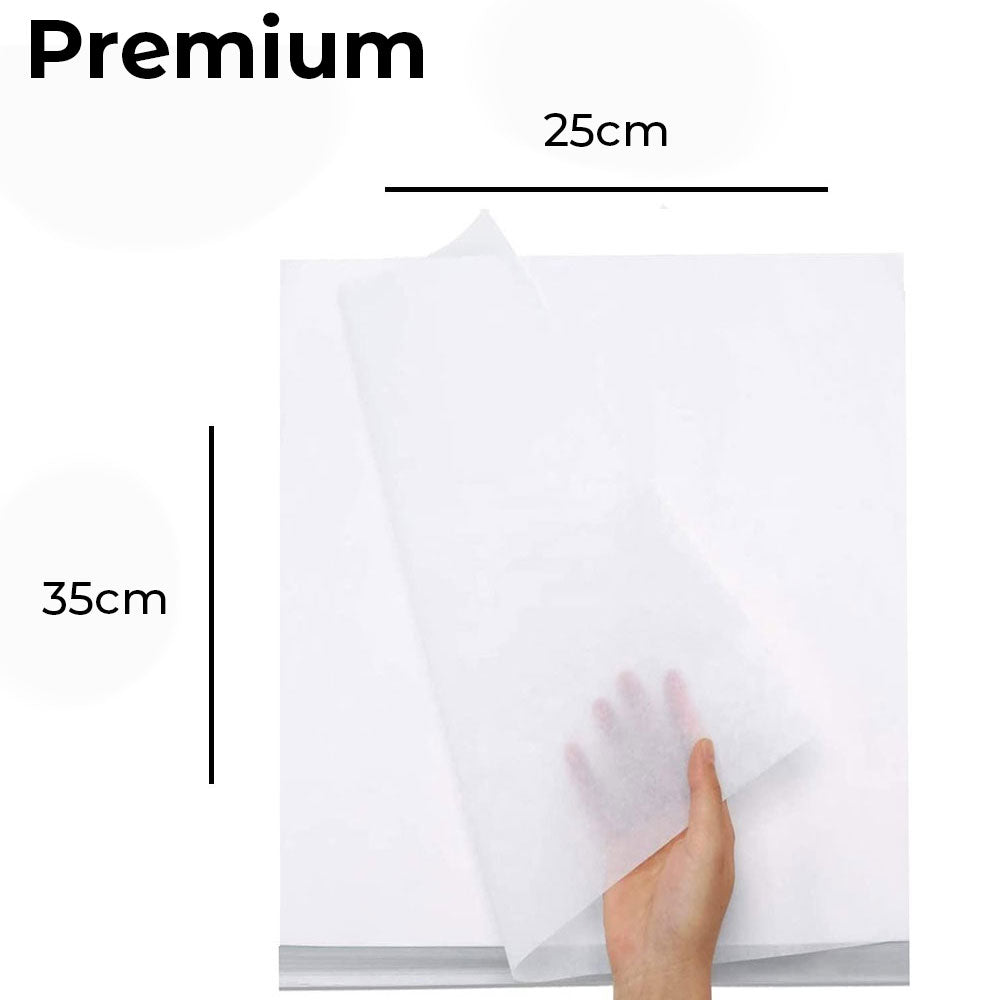 Hand holding a piece of butter paper with dimensions labeled on a white background