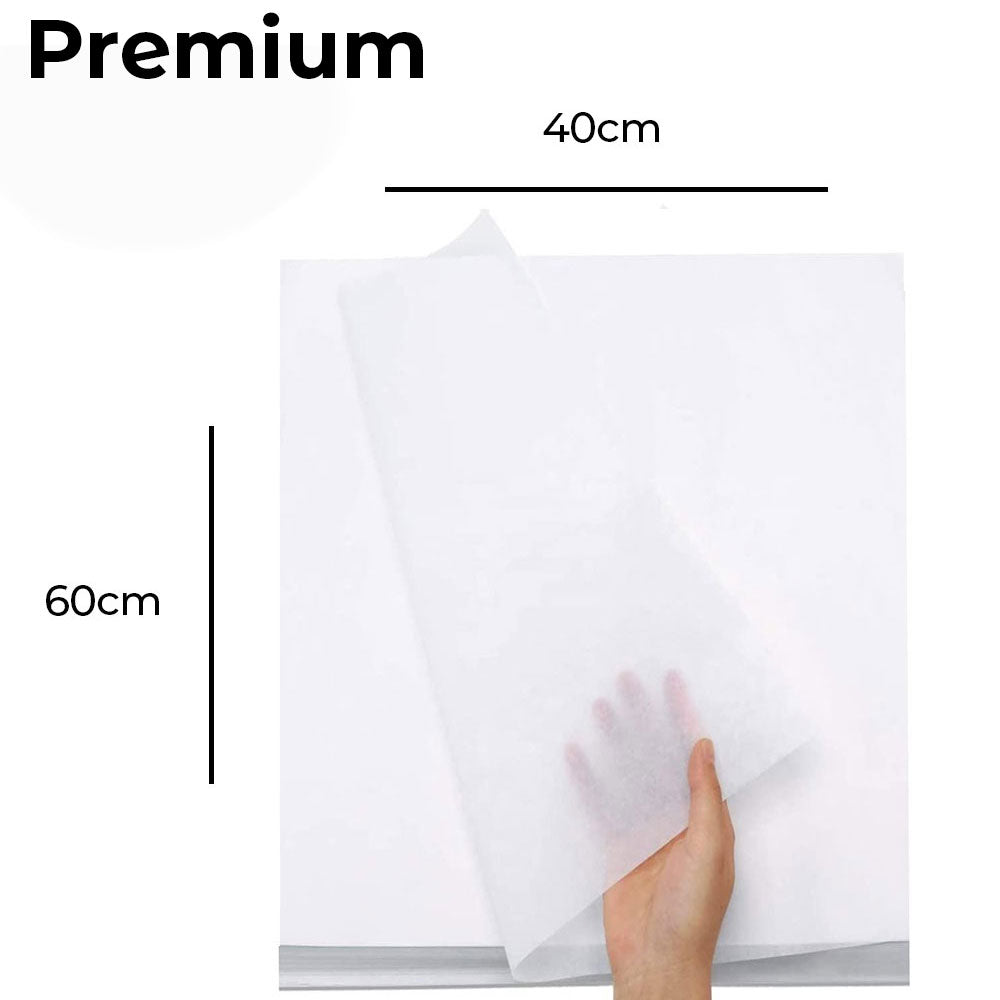 Hand holding a piece of butter paper with dimensions labeled on a white background
