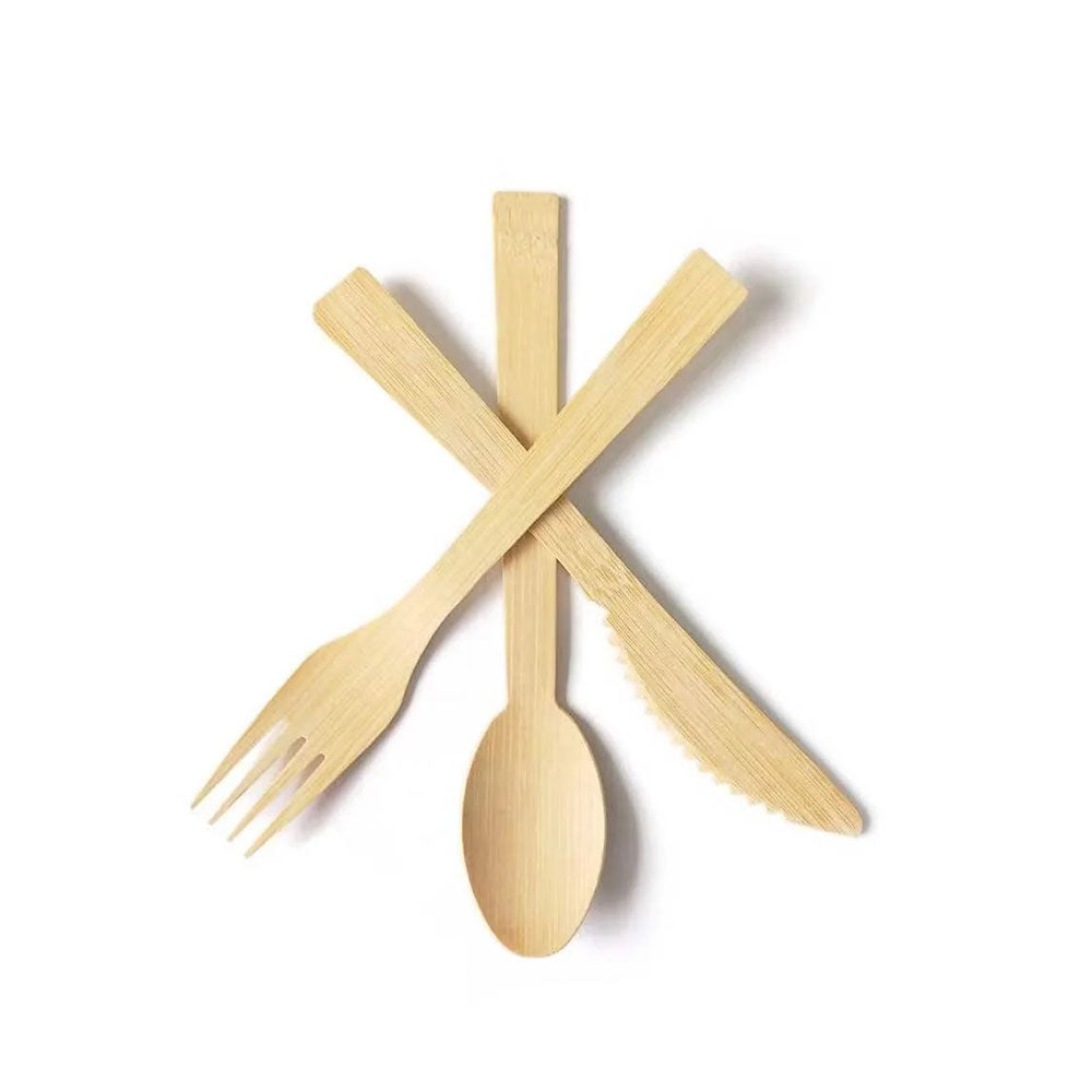 Set of wooden cutlery including a fork, spoon, and knife on a white background