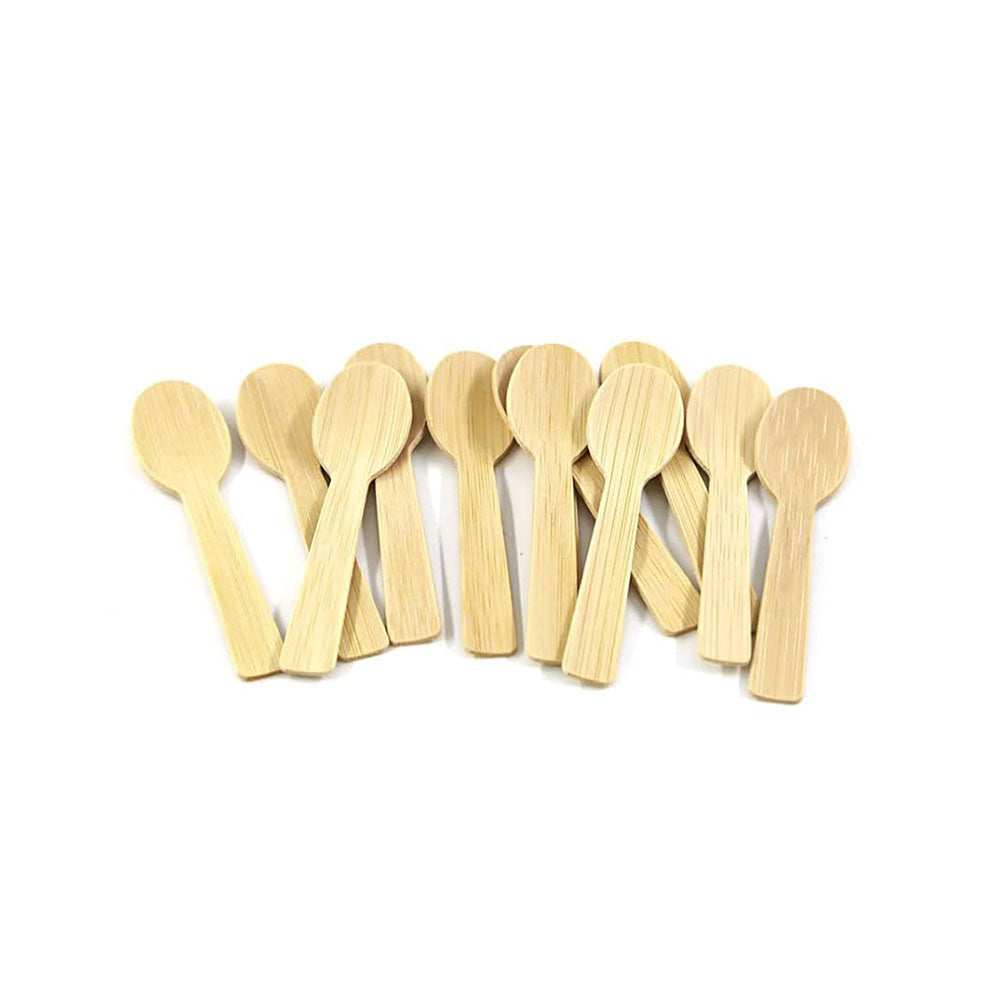 Row of wooden spoons on a white background