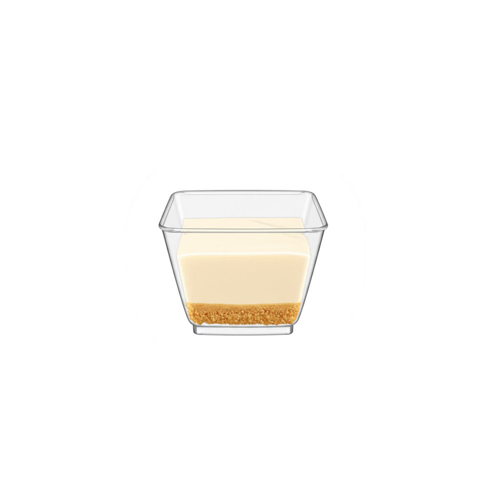 Clear glass dessert dish with a layered dessert on a white background